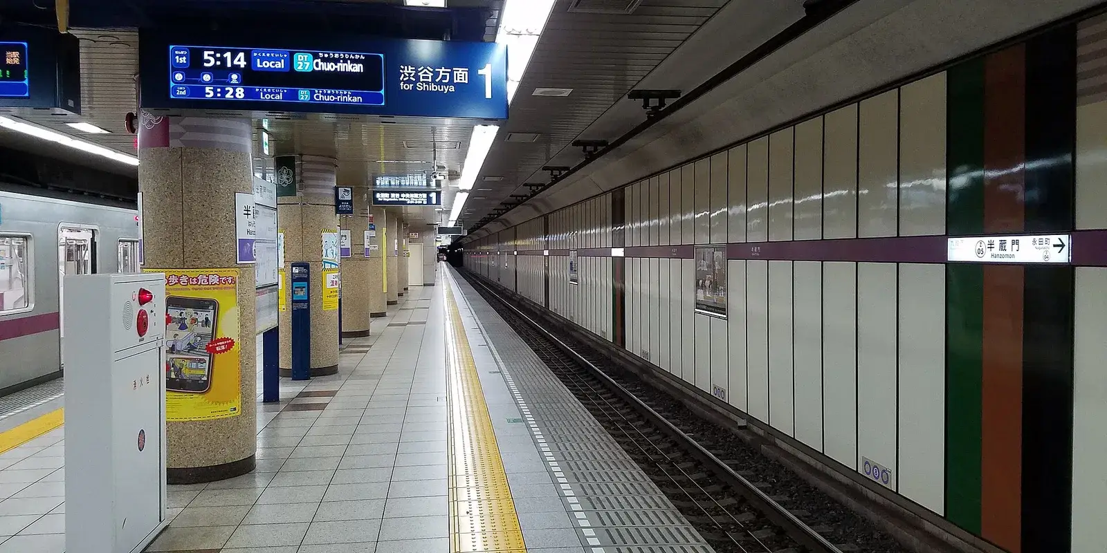 A quiet, empty Tokyo Metro subway platform with a Shibuya-bound departure board and tiled tunnel wall receding into the distance