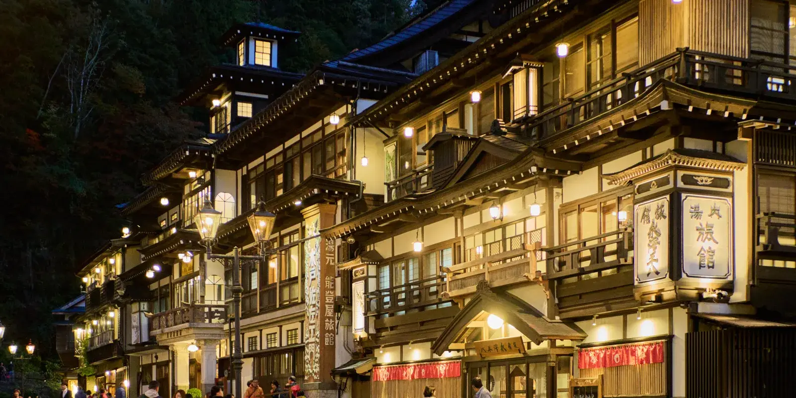 The row of Taisho-era wooden ryokan facing each other across the Ginzan River in Ginzan Onsen, Yamagata