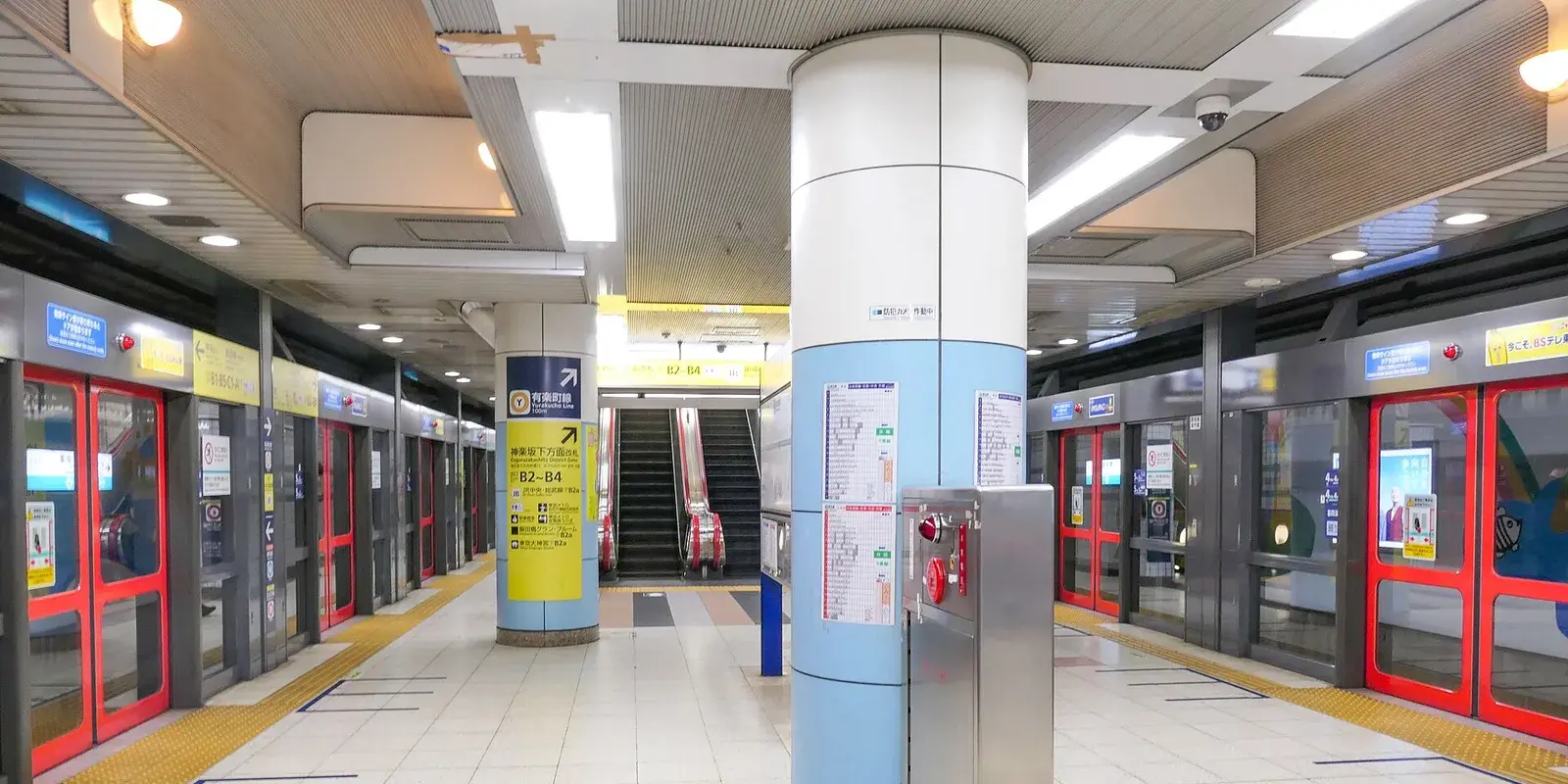 A spotless, brightly lit Tokyo Metro subway platform with polished floors, platform screen doors, and no people