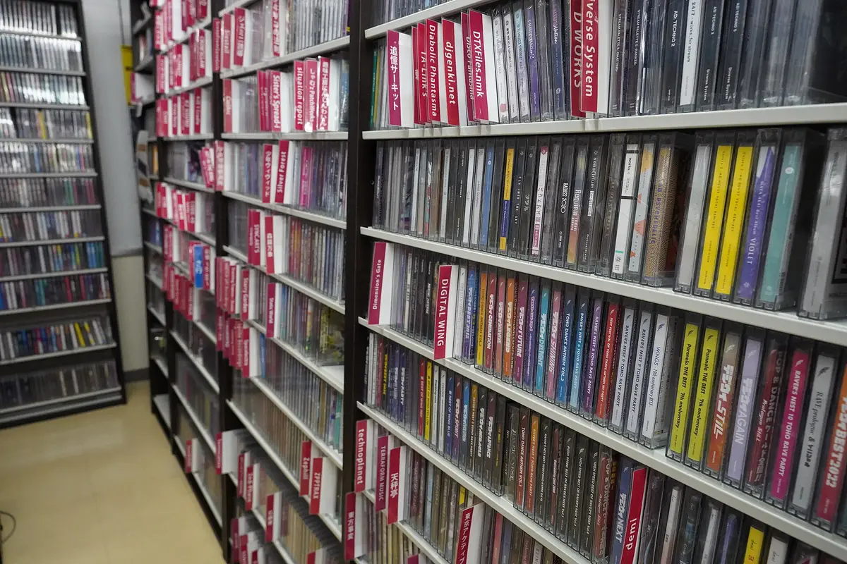 An aisle inside an Akihabara specialty shop, its narrow shelves packed with self-published CD albums behind labelled dividers