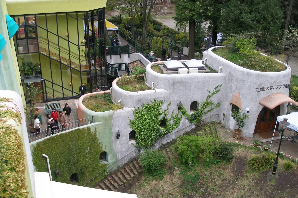 An aerial view of the museum's ivy-covered curved walls and rooftop terrace