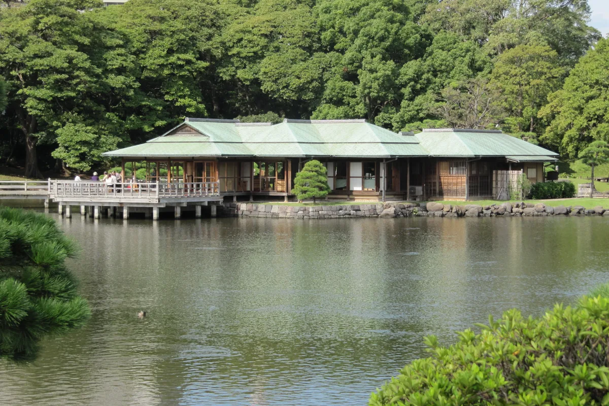The green-roofed Nakajima teahouse on its island in the tidal pond, reached by a wooden bridge, Hama-rikyu Gardens