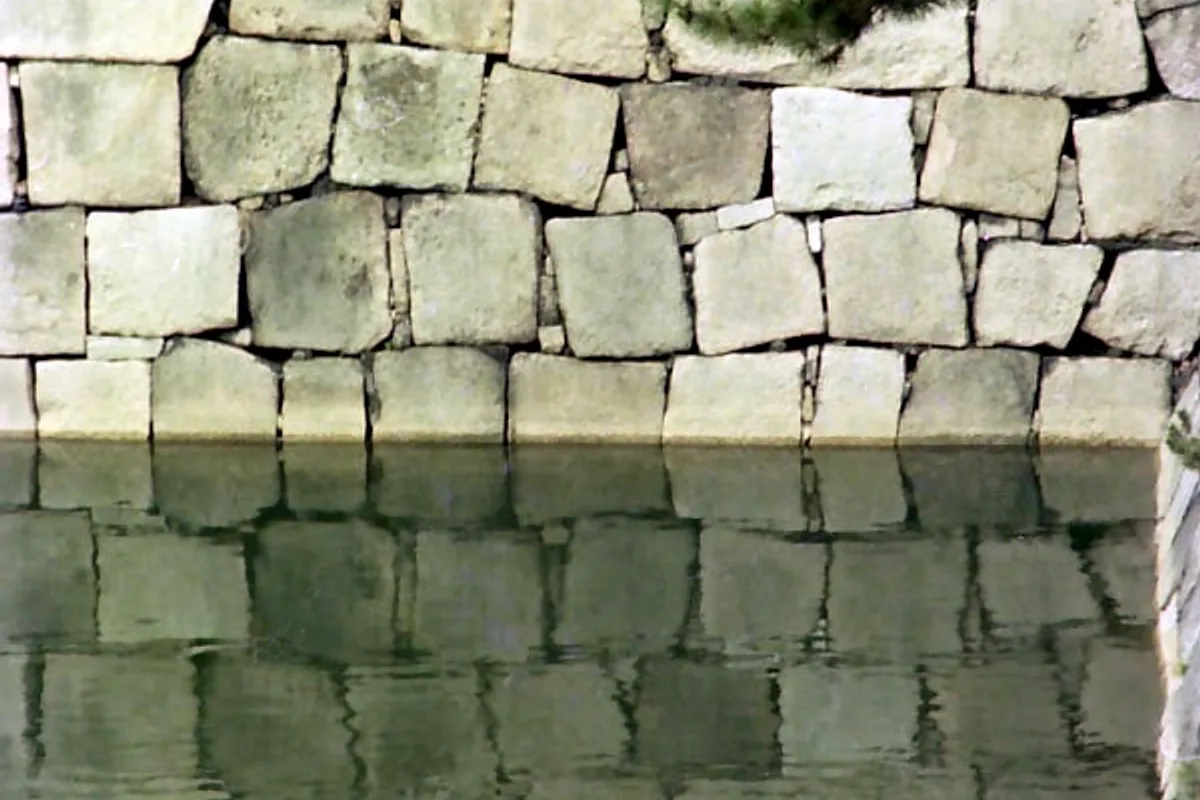 Stone retaining wall and reflection in the moat surrounding Nijo Castle