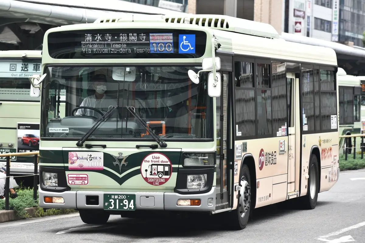 A Kyoto City Bus on the Raku Bus 100 sightseeing route, its front display reading Kiyomizu-dera and Ginkaku-ji