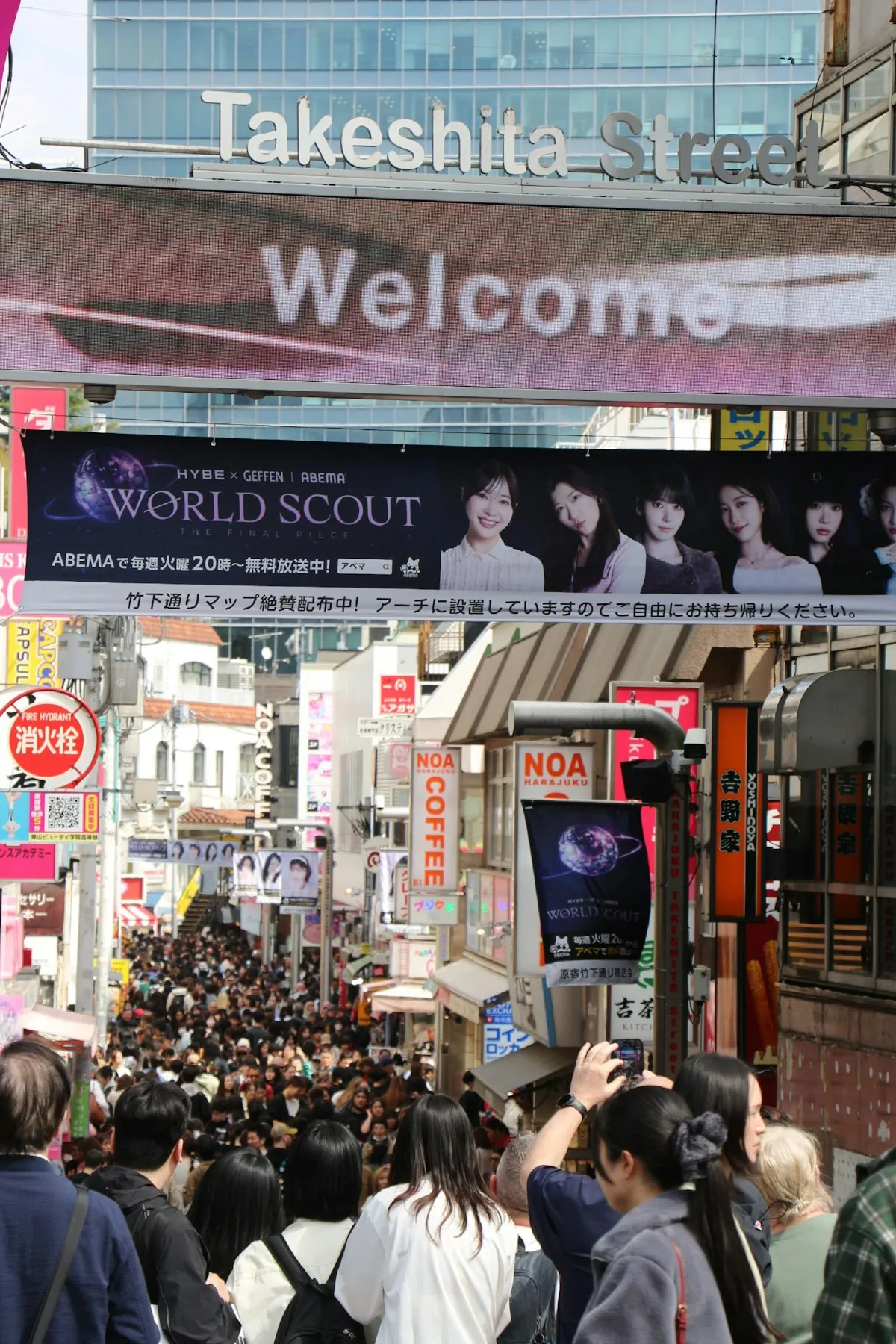 Crowds of shoppers at the entrance of Takeshita Street in Harajuku, Tokyo