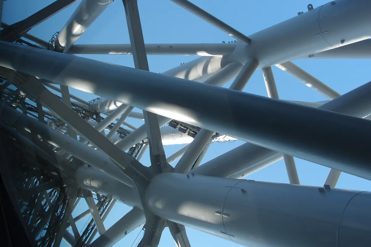 Looking straight up through the tower's steel lattice framework toward the sky