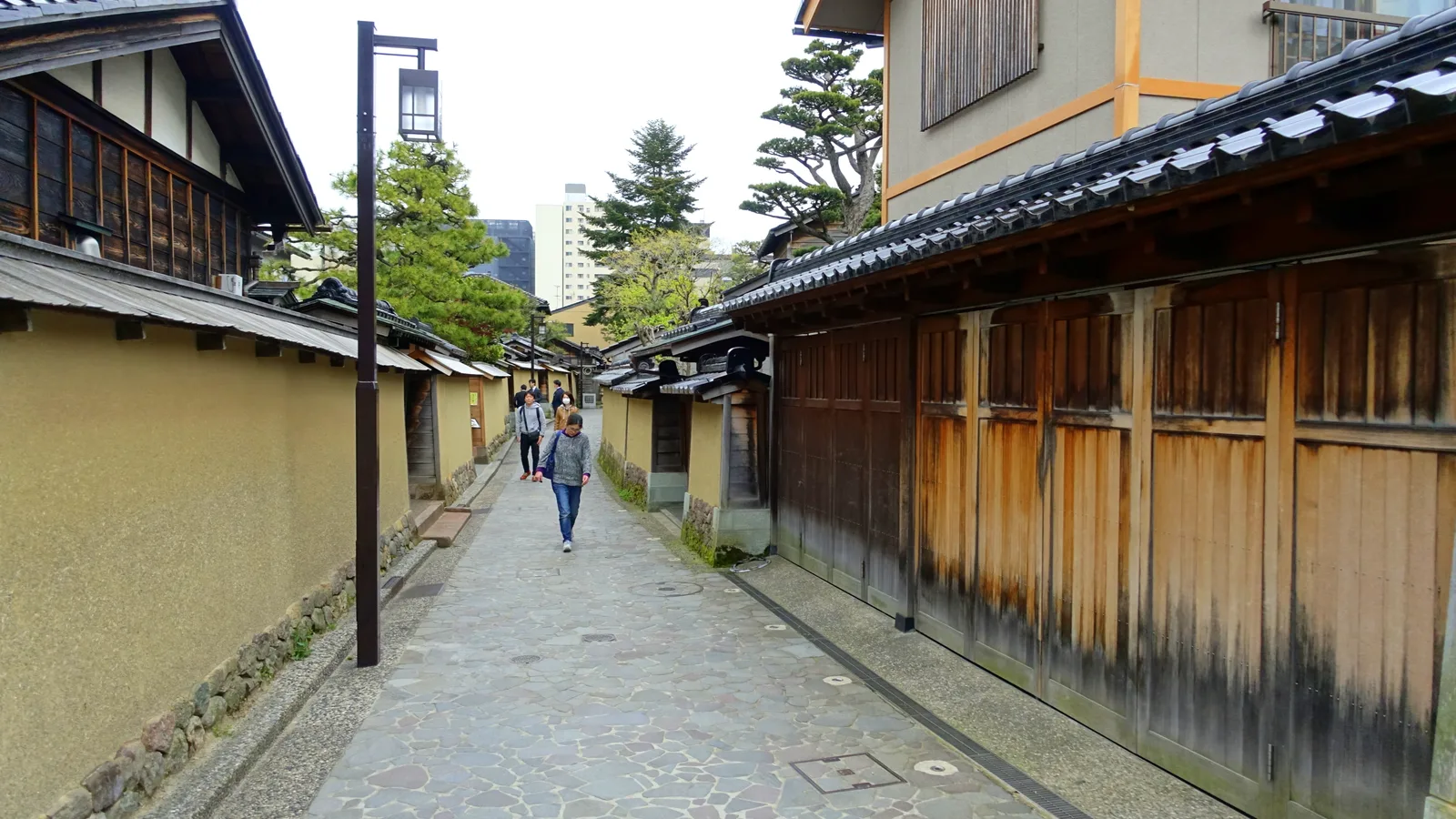 An earthen-walled lane in the Nagamachi former-samurai district of Kanazawa, lined with clay walls and a stone water channel