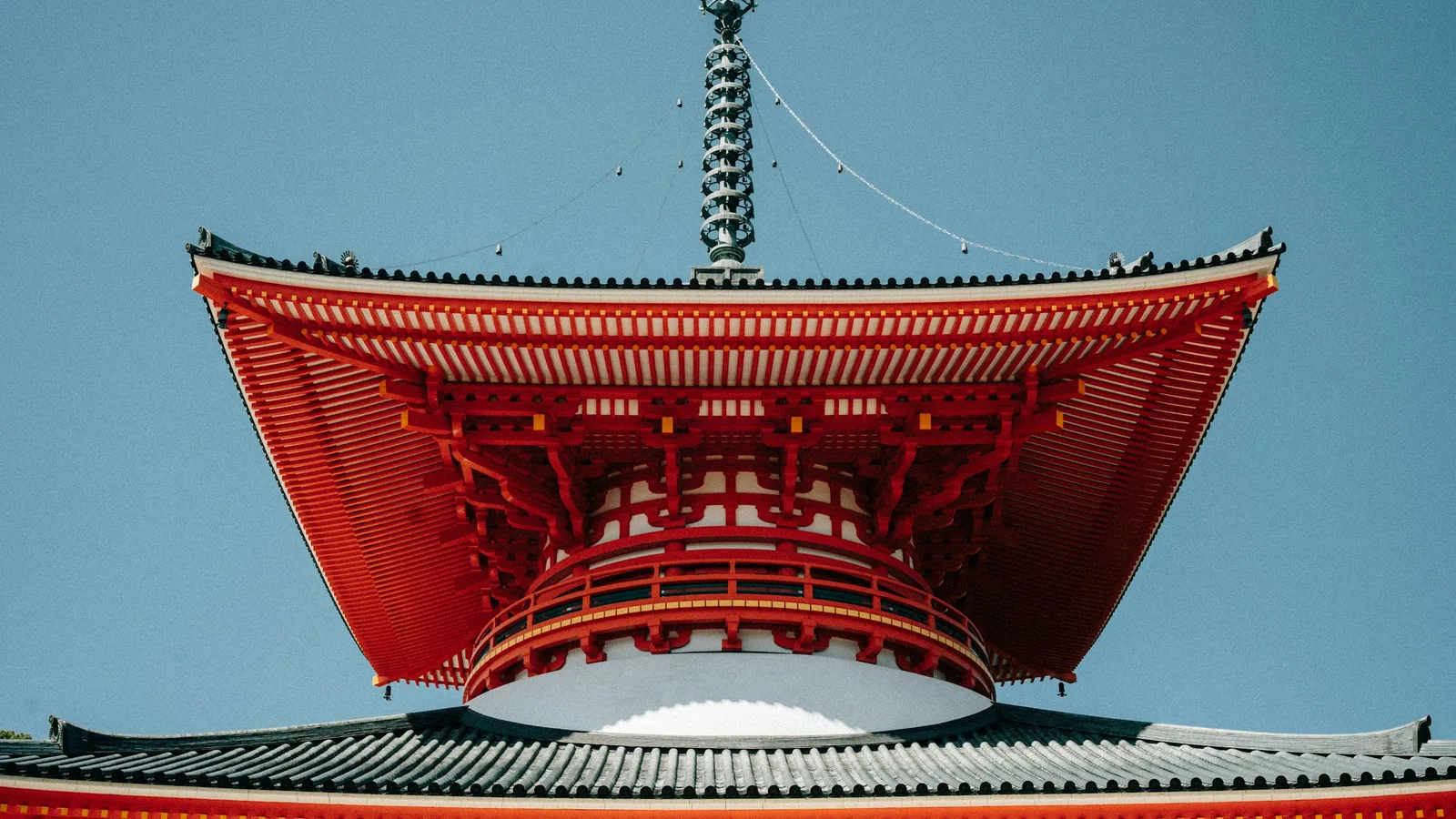 The vermilion Konpon Daito great pagoda rising above the trees in the Danjo Garan precinct of Koyasan