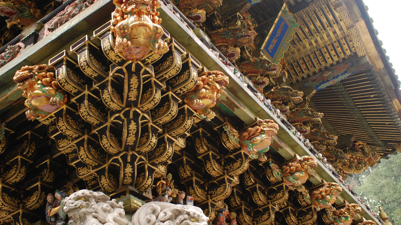 The Yomeimon Gate at Nikko Toshogu, its white and gold tiers crowded with hundreds of painted carvings